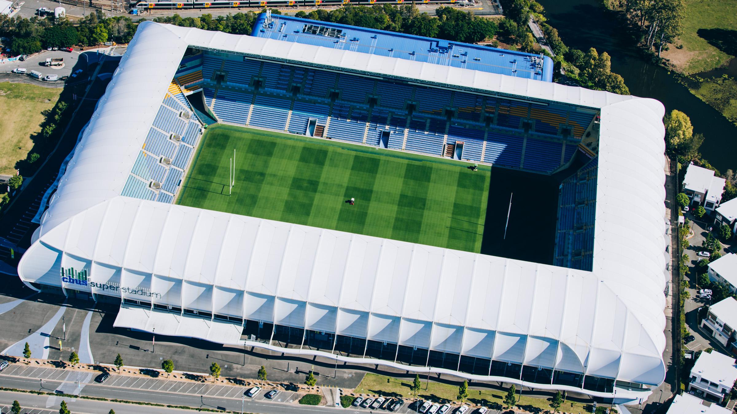 Aerial image of empty Gold Coast Stadium with machinery and workers preparing the field