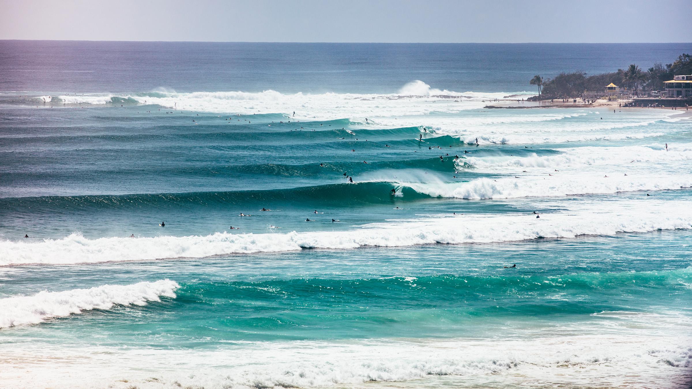 View of ocean with waves and surfers